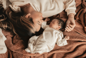 mom and newborn baby laying together after she had therapy in simi valley
